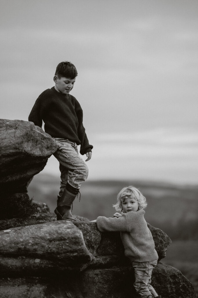 Two boys standing on a rock at Padley Gorge