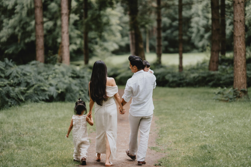 family holding hands walking away