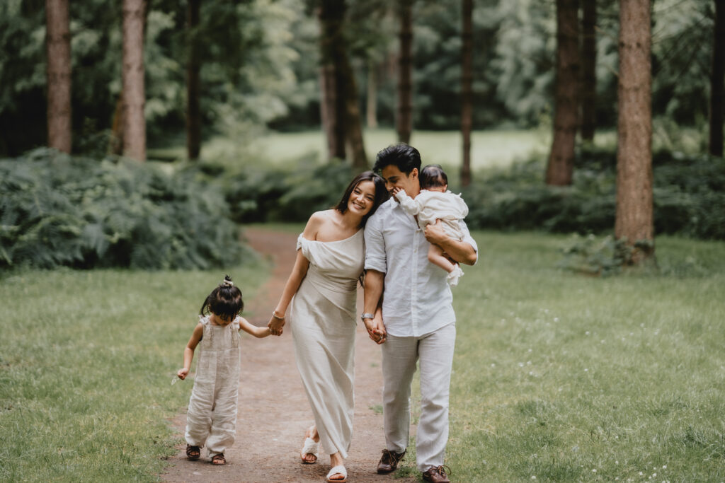 family holding hands walking towards camera