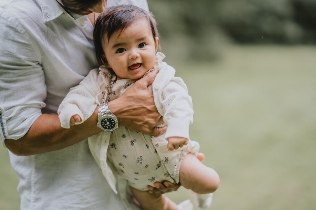 baby smiling at family photoshoot