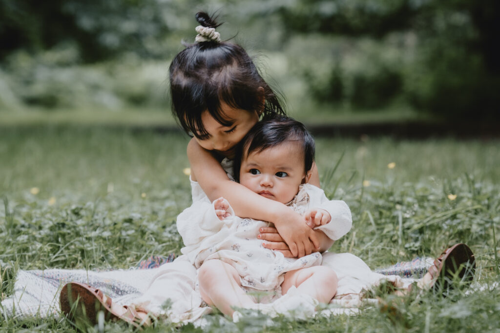 girl holding baby sister