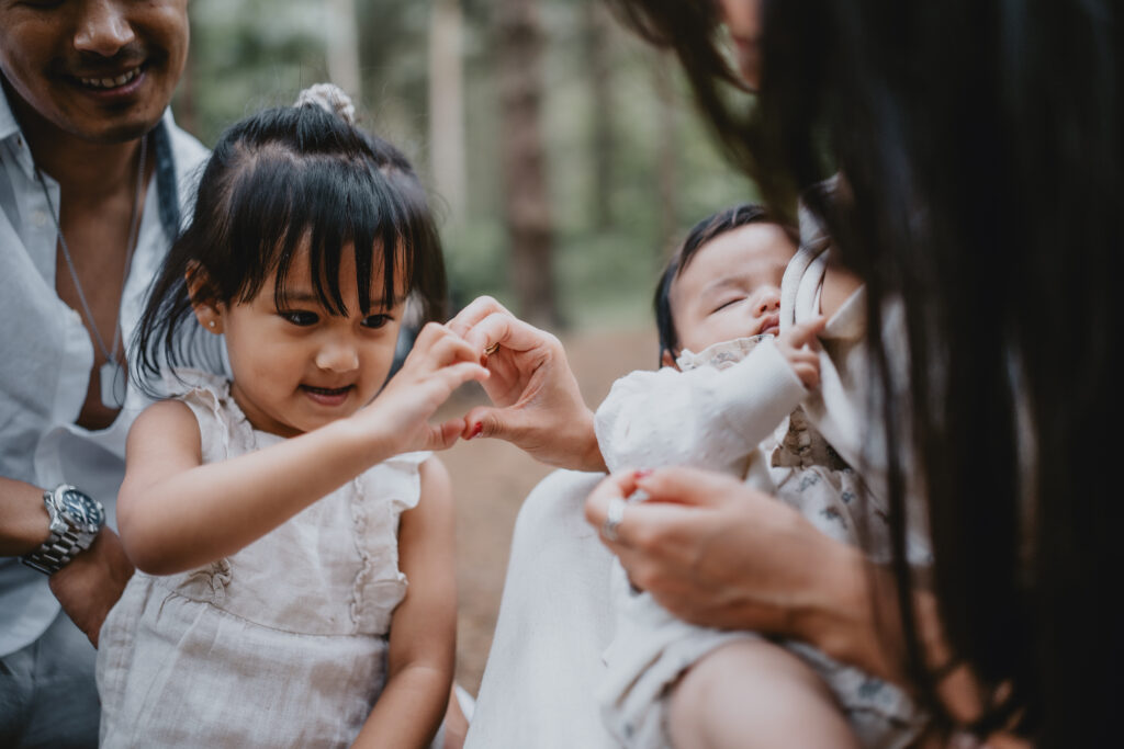 girl and mum making heart shape