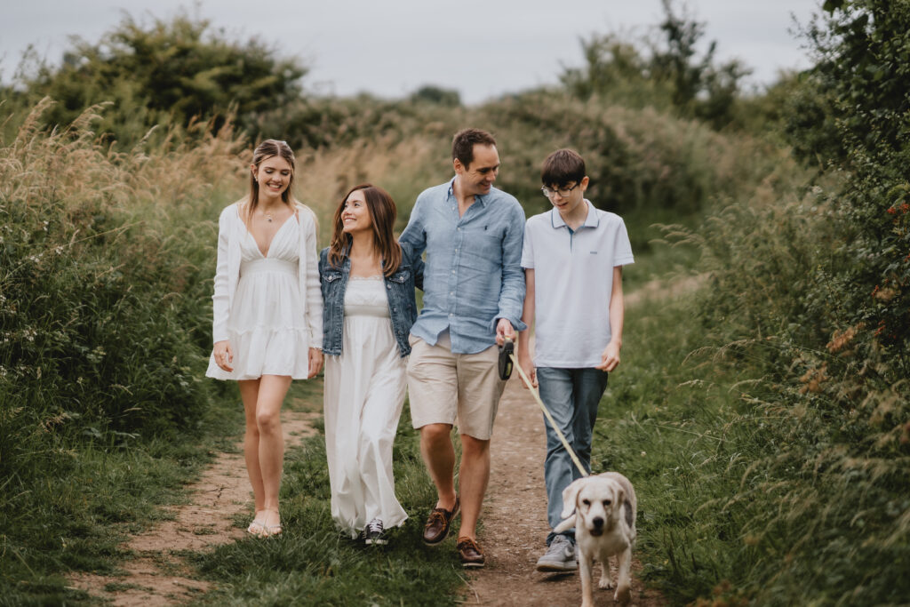 family walking with dog