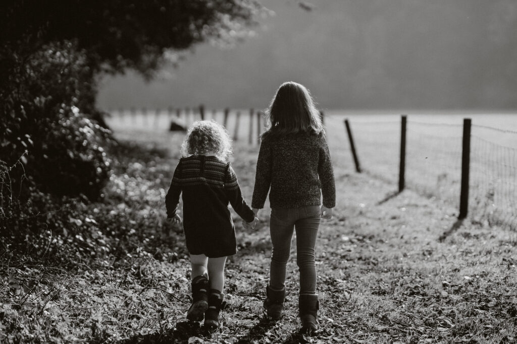 black and white photograph of two children holding hands