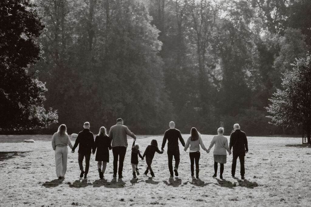 black and white family holding hands